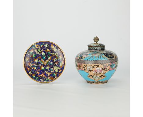 Group of two Japanese cloisonne objects including a lidded urn and a plate. The plate decorated with butterflies among flower