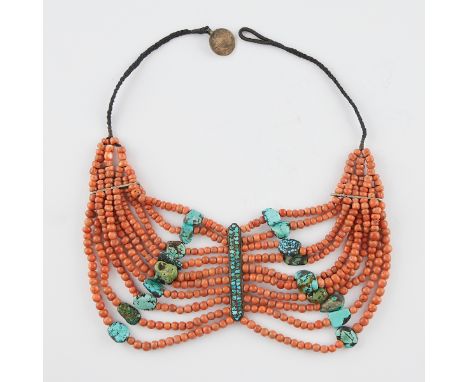 Coral and spiderweb turquoise Indian necklace. With a coin and loop clasp and a woven textile chain.Provenance: From the coll