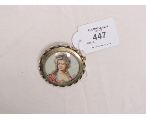 A gilded white metal brooch, with inset painted portrait bust, young female signed Villaume, 2in. diameter