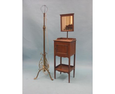 An early 20th century brass floor lamp, tripod base with scroll detail