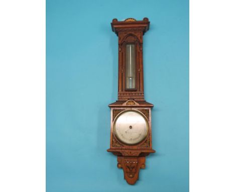 A Victorian oak Gothic Revival barometer by Negretti & Zambra, London, No. 6706, featuring silvered barometer and thermometer