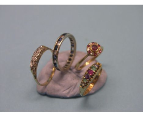 An 18ct. gold Regard ring, one stone lacking, an 18ct. gold rosette ring, set ruby and diamond chips, yellow metal half-hoop 