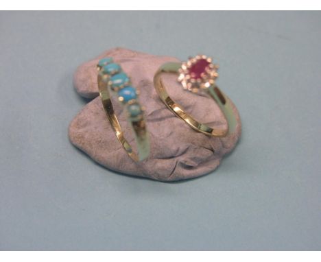 A modern 9ct. gold ring, set ruby and diamond chips, and a yellow metal and turquoise half-hoop ring