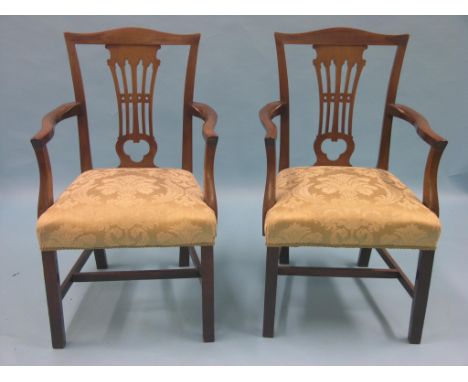 A set of eight Victorian Chippendale mahogany dining chairs, including a pair of armchairs, camel-backs with pierced splats, 
