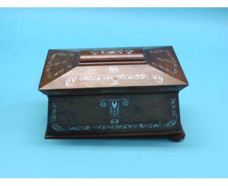 An early Victorian rosewood tea caddy, sarcophagus-shape inlaid throughout with mother of pearl leaf-scrolls, twin enclosed c