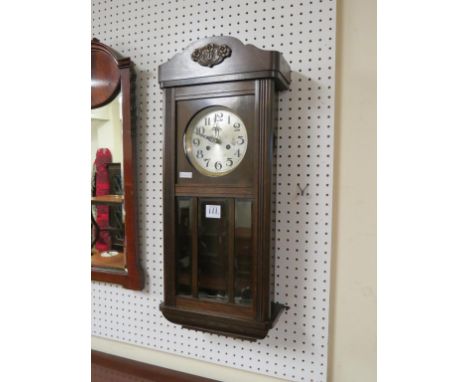 An early 20th century circular mahogany occasional table, with gouged frieze, 1ft. 8in., and a dark oak hall clock, with beve