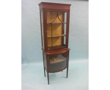 An Edwardian mahogany display cabinet, single astragal-glazed door enclosing lined interior with two shelves, bow fronted gla