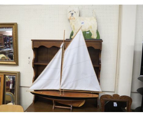 A wood pond yacht, with fore and aft sails, on stand, 38in. including bowsprit, together with an Oriental lacquered wood dome