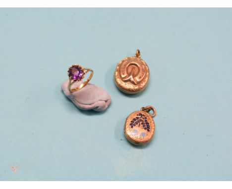 Two engraved yellow metal lockets, each oval, one with enamelled acorn detail, together with a 9ct. gold amethyst dress ring,