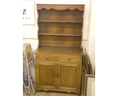 A medium oak linenfold dresser, with twin-shelf plate rack, 3ft. 1in.