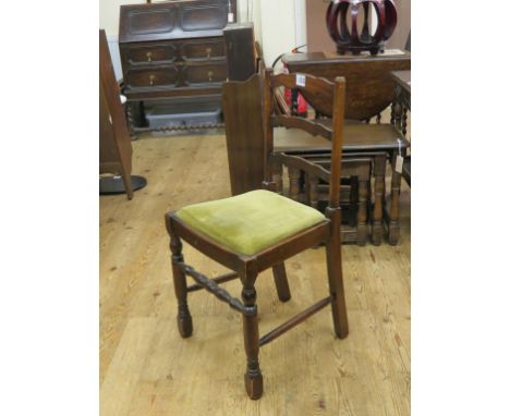A dark oak dining set, circular table with extra leaf, 3ft. 9in., and a set of four ladder-back chairs, with drop-in seats