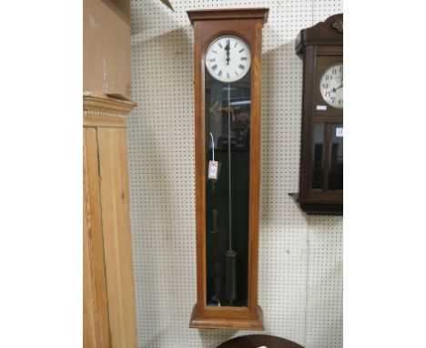 An early electric timepiece, with silvered dial and single glazed trunk door, with pendulum and exposed movement, 50in. hall