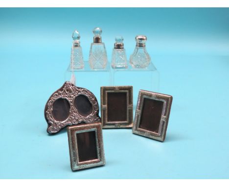 Four silver-mounted portrait photograph frames, tallest 3.5in., and four silver-mounted glass scent bottles, each with stoppe