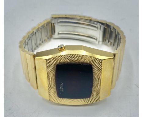 A Quartus 2500 gilt metal digital watch. Red LED face with original bracelet strap. Numbered 2291. 