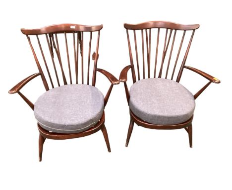 A pair of dark wood Ercol Style stick back chairs 