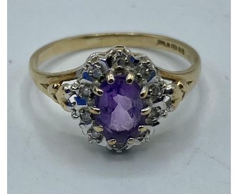 A 9ct gold amethyst and diamond ring. Central oval free cut amethyst  with a surround of illusion set single cut diamonds. 1.
