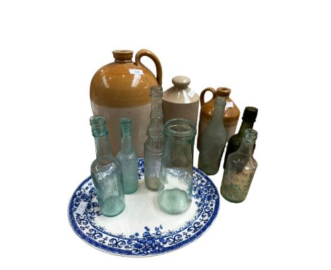 Two slip glazed flagons together with a collection of vintage glass bottles. Largest 34m(h) 