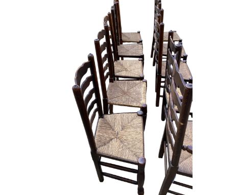A harlequin set of 12 elm ladder back dining chairs with rush seats.(12) 