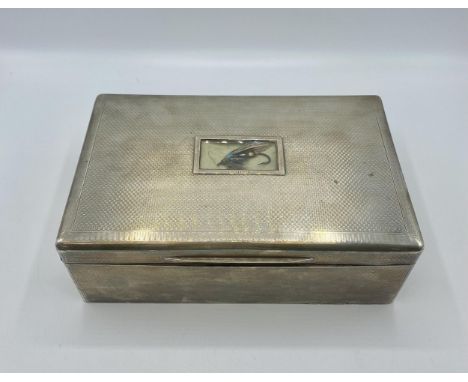 A large sterling silver cedar lined  cigarette/Cigar box. Set with glass panel to top containing a fishing fly and engraved d