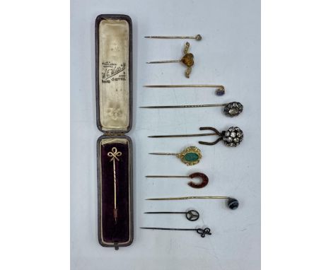 A collection of unmarked yellow and white metal gem and paste set tie pins. 