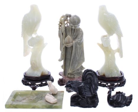 Pair of carved pale jade figures of birds perched upon branches, mounted upon shaped pierced and carved hardwood bases, 7" hi