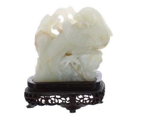 Good Chinese mutton jade carving of a bird and branch, mounted upon a fine pierced carved hardwood stand, 5" high overall, th