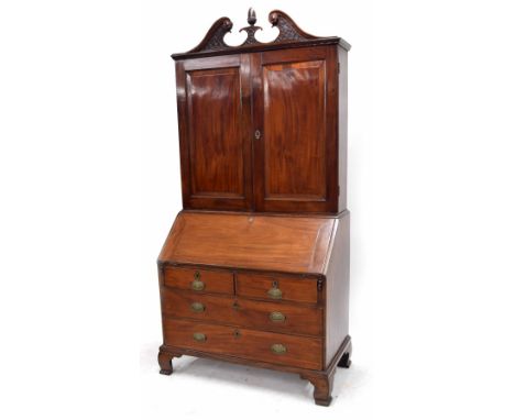 George III mahogany bureau cabinet, with two panelled cupboard doors enclosing a shelved interior and surmounted by a blind f