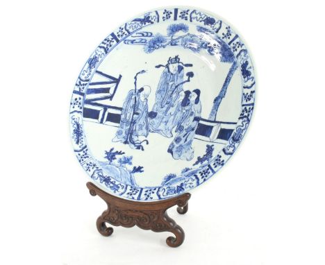 Chinese blue and white porcelain circular charger, decorated with three immortals within foliate borders, 19th century, 15" d