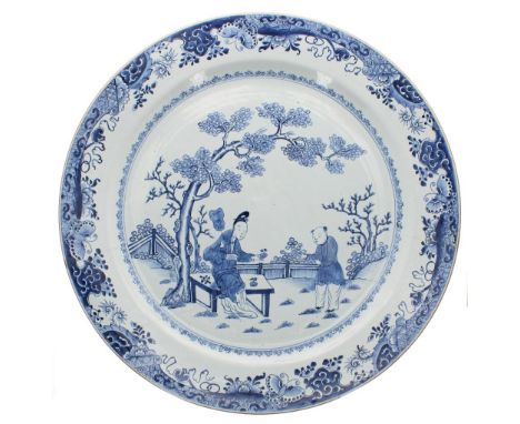 Extremely large 18th century Chinese blue and white porcelain charger, decorated with two figures in a garden landscape enclo