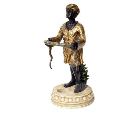 Reproduction resin painted resin stick stand, modelled with a figure holding a snake upon a circular base, 48" high