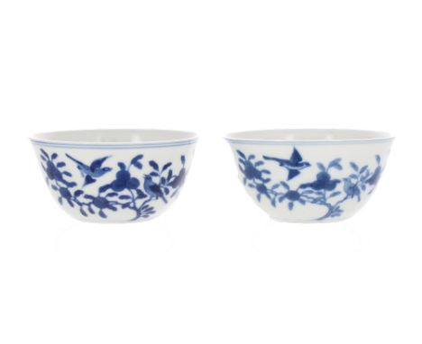 Pair of fine Chinese porcelain blue and white tea bowls, thinly potted and painted internally with a four-petal motif enclosi