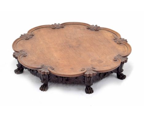 Chinese carved hardwood circular shaped Lazy Susan, the scrolling bordered top carved with feather intervals supported upon e