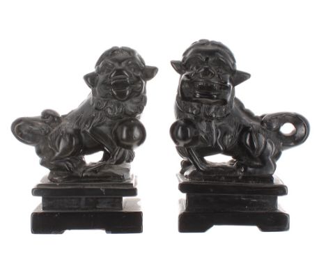 Pair of Chinese carved dark hardstone figures of Buddhistic lions, upon rectangular plinth bases, 4.25" high - ** one Bearing