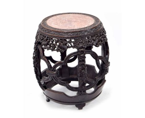 Good Chinese hardwood barrel shaped side table, the pink marble top within a continuous band of carved fruiting vines, the op