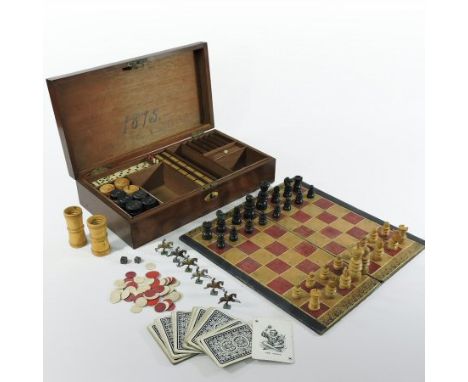 A Victorian games compendium, fitted with various games to include chess, cribbage, bone dominoes, playing cards in a fitted 