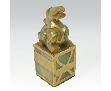 A Chinese jade and gilt painted seal, in the form of a dog of Fo, 11cm high