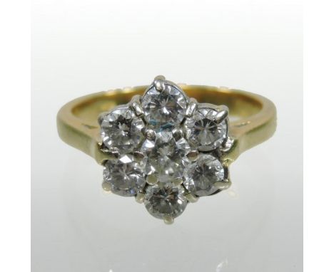 An 18 carat gold seven stone daisy set diamond cluster ring