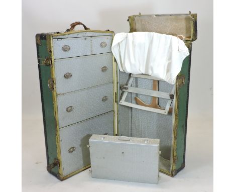 An early 20th century metal bound travelling trunk, with a fitted interior, bearing various Cunard Line travel labels, 110cm