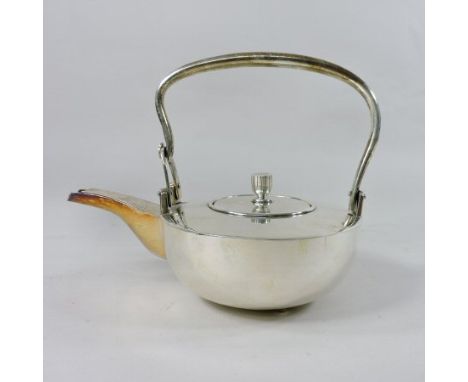 An early 20th century oriental white metal teapot and cover, of compressed circular shape, with a swing handle, Jungin mark t