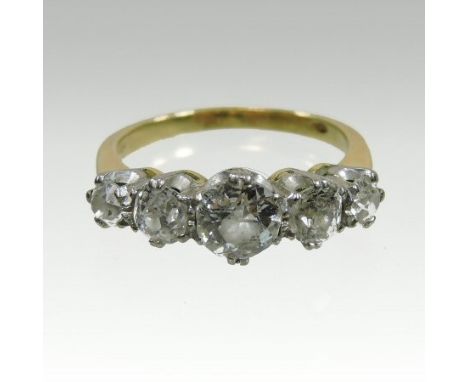 An 18 carat gold five stone diamond ring, set with a row of graduated old cut diamonds, approximately 1.5 carat gross