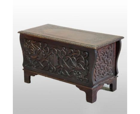 A mid 20th century carved oak coffer, with a hinged lid, decorated with scrolling Celtic designs and inscribed Southwold Carv
