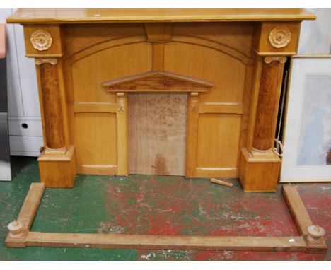 Oak architectural fire surround with an applied relief rodent, with kerb, 97cm high and 146cm wide (the aperture 55cm high an