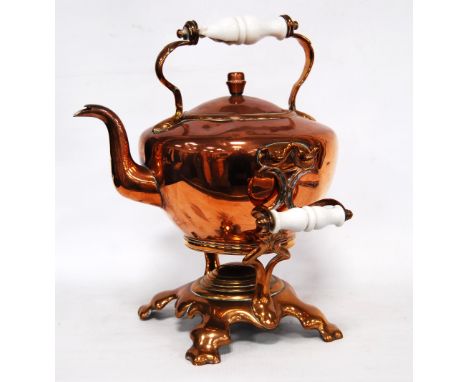 Copper kettle on stand with ceramic handle.