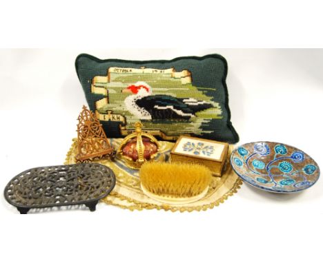 Indian gilt table mat, leather fake book, ivory hairbrush, miniature easel, crown finial, cushion and a trivet.