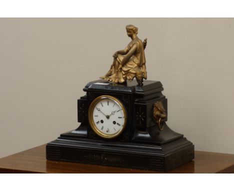 Late 19th century black slate mantel clock with gilt metal seated maiden figure, engraved decoration, barrel movement strikin