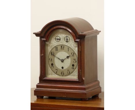 Early 20th century mahogany case mantel clock, arched door with bevelled glass, triple train movement striking the hours and 