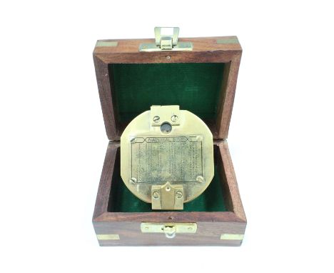 A brass compass, in a brass bound box bearing an applied anchor device 