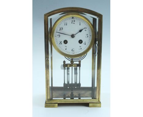 An early 20th Century French brass mantle clock, having a drum movement with a mercury pendulum, striking on a gong, the whit