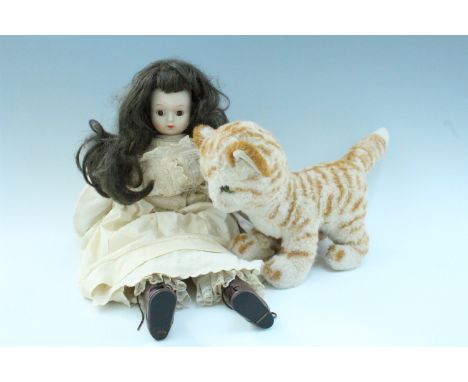 A 20th Century bisque headed doll, having glass eyes, together with a Steiff kitten, former 50 cm