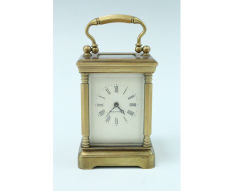 A mid 20th Century diminutive brass carriage clock, key wind and set, the case having hexagonal corner columns and bevelled g